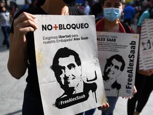 People hold signs with the image of Colombian businessman Alex Saab, who was estradited to the US, during a demonstration demanding his release, at the Bolivar square in Caracas, on October 17, 2021. Venezuela's opposition called on President Nicolas Maduro's government to resume talks to resolve their differences, after the ruling party withdrew from the latest round that was to begin Sunday in Mexico. (Photo by Federico PARRA / AFP) David Rivkin Statement on Alex Saab
