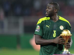 Senegal's defender Kalidou Koulibaly holds the trophy prior to the ceremony after winning after the Africa Cup of Nations (CAN) 2021 final football match between Senegal and Egypt at Stade d'Olembe in Yaounde on February 6, 2022. (Photo by Kenzo TRIBOUILLARD / AFP)
