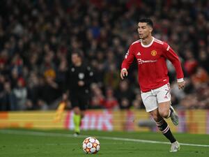 Manchester United's Portuguese striker Cristiano Ronaldo runs with the ball during the UEFA Champions League round of 16 second leg football match between Manchester United and Atletico Madrid at Old Trafford stadium in Manchester, north west England on March 15, 2022. (Photo by Paul ELLIS / AFP)