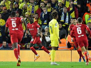 Liverpool's Senegalese striker Sadio Mane celebrates after scoring his team second goal during the UEFA Champions League semi-final first leg football match between Liverpool and Villarreal, at the Anfield Stadium, in Liverpool, on April 27, 2022. (Photo by Oli SCARFF / AFP)
