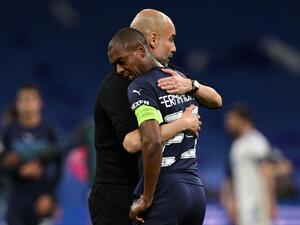 Manchester City's Spanish manager Pep Guardiola (L) hugs Manchester City's Brazilian midfielder Fernandinho after the UEFA Champions League semi-final second leg football match between Real Madrid CF and Manchester City at the Santiago Bernabeu stadium in Madrid on May 4, 2022. Real Madrid won the match 3-1. (Photo by Paul ELLIS / AFP)