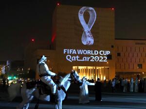 ile photo taken on September 3, 2019, a mounted policeman rides past a building on which the official logo of the FIFA World Cup Qatar 2022 logo is projected at the Qatari capital Doha's traditional Souq Waqif market. Migrant labourers are working through the night near the World Cup clock that will start counting down 200 days to kick-off on May 5, 2022, with hosts Qatar facing mounting questions over costs and conditions for fans. (Photo by AFP)