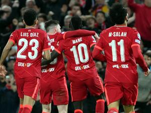 Liverpool's Senegalese striker Sadio Mane celebrates with teammates after scoring his team second goal during the UEFA Champions League semi-final first leg football match between Liverpool and Villarreal, at the Anfield Stadium, in Liverpool, on April 27, 2022. (Photo by LLUIS GENE / AFP)