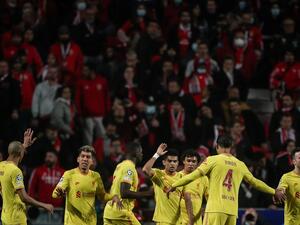 Liverpool's Colombian midfielder Luis Diaz (C) celebrates with teammates after scoring his team's third goal during the UEFA Champions League quarter final first leg football match between SL Benfica and Liverpool FC at the Luz stadium in Lisbon on April 5, 2022. (Photo by CARLOS COSTA / AFP)