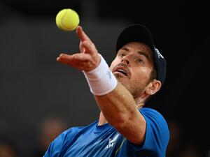 Great Britain's Andy Murray serves to Austria's Dominic Thiem during their 2022 ATP Tour Madrid Open tennis tournament singles match at the Caja Magica in Madrid on May 2, 2022. (Photo by GABRIEL BOUYS / AFP)