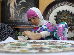 Rahma is an expert on painting Madaba's mosaics