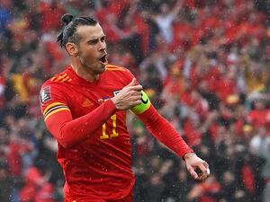  Wales' striker Gareth Bale celebrates after hitting a free kick and Ukraine scoring an own goal opening the score during the FIFA World Cup 2022 play-off final qualifier football match between Wales and Ukraine at the Cardiff City Stadium in Cardiff, south Wales, on June 5, 2022. (Photo by Paul ELLIS / AFP)