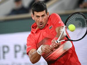 Serbia's Novak Djokovic returns the ball to Spain's Rafael Nadal during their men's quarter-final singles match on day ten of the Roland-Garros Open tennis tournament at the Court Philippe-Chatrier in Paris early on June 1, 2022. (Photo by Anne-Christine POUJOULAT / AFP)