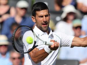 Serbia's Novak Djokovic returns the ball to Canada's Felix Auger-Aliassime during their men's exhibition singles match at The Giorgio Armani Tennis Classic tournament at the Hurlingham Club, in London, on June 22, 2022. (Photo by Adrian DENNIS / AFP)