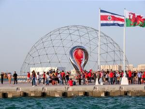 A general view shows the flags of (L to R) Costa Rica and Wales, the countries most-recently qualified for the 2022 World Cup flying with others in the Qatari capital Doha during a flag-raising ceremony of the last remaining countries to qualify, on June 16, 2022. (Photo by Mustafa ABUMUNES / AFP)