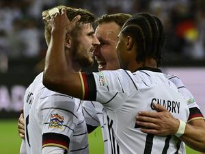 Germany's forward Timo Werner (L) celebrates scoring the 4-0 goal with his teammates during the UEFA Nations League football match Germany v Italy at the Borussia Park stadium in Moenchengladbach, western Germany, on June 14, 2022. (Photo by John MACDOUGALL / AFP)