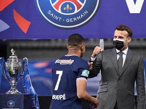 Paris Saint-Germain's French forward Kylian Mbappe is congratulated by French president Emmanuel Macron after winning the French Cup final football match between Paris Saint-Germain and Monaco at the Stade de France stadium, in Saint-Denis, on the outskirts of Paris, on May 19, 2021. / AFP / FRANCK FIFE