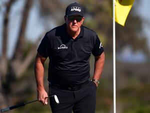 Phil Mickelson lines up his putt on the 10th hole green during the second round of The Farmers Insurance Open on the North Course at Torrey Pines Golf Course on January 27, 2022 in La Jolla, California. Donald Miralle/Getty Images/AFP (Photo by DONALD MIRALLE / GETTY IMAGES NORTH AMERICA / Getty Images via AFP)