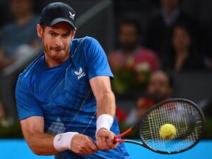 Great Britain's Andy Murray returns the ball to Austria's Dominic Thiem during their 2022 ATP Tour Madrid Open tennis tournament singles match at the Caja Magica in Madrid on May 2, 2022. (Photo by GABRIEL BOUYS / AFP)