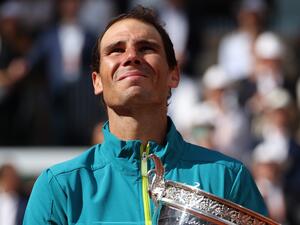 Spain's Rafael Nadal poses with The Musketeers' Cup as he celebrates after victory over Norway's Casper Ruud during their men's singles final match on day fifteen of the Roland-Garros Open tennis tournament at the Court Philippe-Chatrier in Paris on June 5, 2022. (Photo by Thomas SAMSON / AFP)