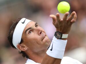 Spain's Rafael Nadal serves to Canada's Felix Auger-Aliassime during their men's exhibition singles match at The Giorgio Armani Tennis Classic tournament at the Hurlingham Club in London on June 24, 2022. (Photo by Adrian DENNIS / AFP)