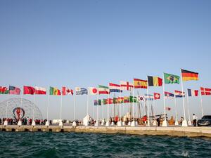A general view shows flags of the qualified countries for the 2022 World Cup in the Qatari capital Doha during a flag-raising ceremony of the last remaining countries to qualify, on June 16, 2022. (Photo by Mustafa ABUMUNES / AFP)