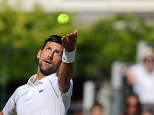Serbia's Novak Djokovic serves the ball to Canada's Felix Auger-Aliassime during their men's exhibition singles match at The Giorgio Armani Tennis Classic tournament at the Hurlingham Club, in London, on June 22, 2022. (Photo by Adrian DENNIS / AFP)