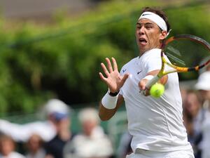 Spain's Rafael Nadal returns to Canada's Felix Auger-Aliassime during their men's exhibition singles match at The Giorgio Armani Tennis Classic tournament at the Hurlingham Club in London on June 24, 2022. (Photo by Adrian DENNIS / AFP)