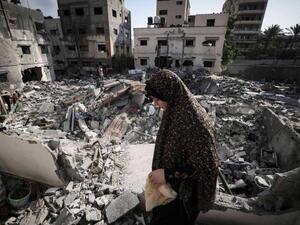 Woman amidst the rubble in Gaza 
