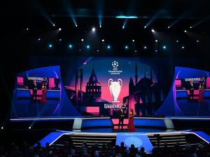 UEFA Managing Director of Communications Pedro Pinto (L) looks on next to British journalist Reshmin Chowdhury on stage during the draw ceremony for the 2022-2023 UEFA Champions League football tournament in Istanbul on August 25, 2022. (Photo by OZAN KOSE / AFP)