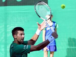 Serbian tennis player Novak Djokovic returns the ball during an exhibition match, organised to mark the opening of a tennis court at the "Archaeological park of the Bosnian pyramid" near Visoko, north of Sarajevo, on July 13, 2022. (Photo by ELVIS BARUKCIC / AFP)