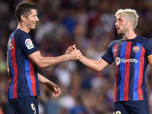 Barcelona's Spanish defender Sergi Roberto (R) celebrates with Barcelona's Polish forward Robert Lewandowski after scoring his team's fourth goal during the Spanish League football match between FC Barcelona and Real Valladolid FC at the Camp Nou stadium in Barcelona on August 28, 2022. (Photo by Josep LAGO / AFP)
