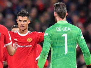 Manchester United's Portuguese striker Cristiano Ronaldo celebrates with Manchester United's Spanish goalkeeper David de Gea at the final whistle in the UEFA Champions league group F football match between Manchester United and Villarreal at Old Trafford stadium in Manchester, north west England, on September 29, 2021. Manchester United won the match 2-1. (Photo by Anthony Devlin / AFP)
