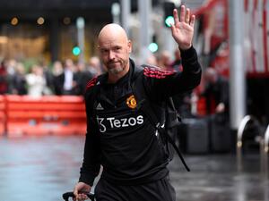 Manchester United's manager Erik Ten Hag ways as he walks towards the hotel upon team arrival in Melbourne on July 13, 2022, ahead of their exhibition football match against Melbourne Victory. (Photo by Martin KEEP / AFP)