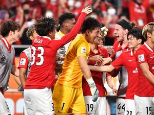 Urawa Reds' players including Japanese goalkeeper Shusaku Nishikawa celebrate after winning the AFC Champions League semi-final football match between South Korea's Jeonbuk Hyundai Motors FC and Japan's Urawa Red Diamonds in Saitama, on August 25, 2022. (Photo by Kazuhiro NOGI / AFP)