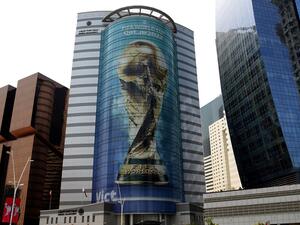 An image of the FIFA 2022 World Cup trophy adorns a building in the Qatari capital Doha on August 16, 2022. (Photo by Mustafa ABUMUNES / AFP)