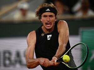 Germany's Alexander Zverev plays a backhand return to Spain's Rafael Nadal during their men's semi-final singles match on day thirteen of the Roland-Garros Open tennis tournament at the Court Philippe-Chatrier in Paris on June 3, 2022. (Photo by Christophe ARCHAMBAULT / AFP)