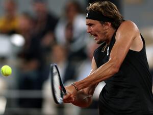 Germany's Alexander Zverev plays a backhand return to Spain's Rafael Nadal during their men's semi-final singles match on day thirteen of the Roland-Garros Open tennis tournament at the Court Philippe-Chatrier in Paris on June 3, 2022. (Photo by Thomas SAMSON / AFP)