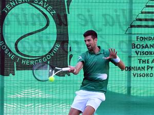 Serbian tennis player Novak Djokovic returns the ball during an exhibition match, organised to mark the opening of a tennis court at the "Archaeological park of the Bosnian pyramid" near Visoko, north of Sarajevo, on July 13, 2022. (Photo by ELVIS BARUKCIC / AFP)