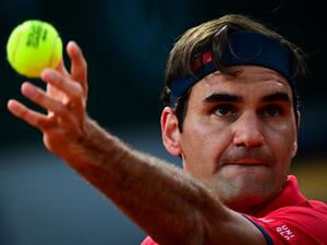 Switzerland's Roger Federer serves the ball to Germany's Dominik Koepfer during their men's singles third round tennis match on Day 7 of The Roland Garros 2021 French Open tennis tournament in Paris on June 5, 2021. (Photo by MARTIN BUREAU / AFP)