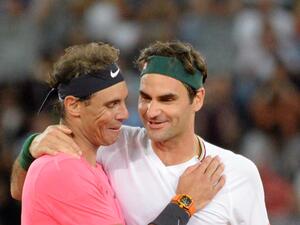 Switzerland's Roger Federer (R) hugs Spain's Rafael Nadal (L) during their tennis match at The Match in Africa at the Cape Town Stadium, in Cape Town on February 7, 2020. / AFP / RODGER BOSCH