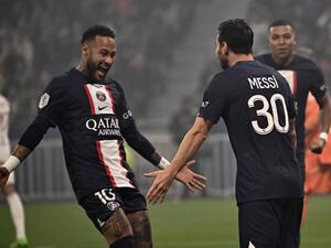 Paris Saint-Germain's Argentine forward Lionel Messi (R) is congratulated by Paris Saint-Germain's Brazilian forward Neymar after scoring a goal during the French L1 football match between Olympique Lyonnais (OL) and Paris Saint-Germain (PSG) at The Groupama Stadium in Decines-Charpieu, central-eastern France, on September 18, 2022. (Photo by Olivier CHASSIGNOLE / AFP)