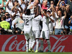 Real Madrid's Brazilian forward Vinicius Junior (C) celebrates with Real Madrid's French midfielder Eduardo Camavinga (L) and Real Madrid's Brazilian forward Rodrygo (R) after scoring his team's first goal during the Spanish league football match between Real Madrid CF and Real Betis at the Santiago Bernabeu stadium in Madrid on September 3, 2022. (Photo by Thomas COEX / AFP)