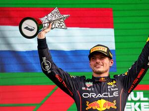 Red Bull Racing's Dutch driver Max Verstappen holds the winner's trophy on the podium of the Dutch Formula One Grand Prix at the Zandvoort circuit on September 4, 2022. (Photo by Kenzo TRIBOUILLARD / AFP)