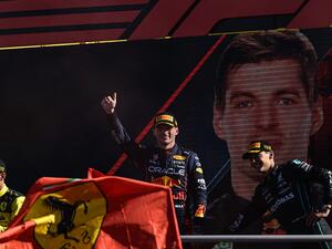 Winner Red Bull Racing's Dutch driver Max Verstappen (C) celebrates with second-placed Ferrari's Monegasque driver Charles Leclerc (L) and third-placed Mercedes' British driver George Russell (R) on the podium after the Italian Formula One Grand Prix at the Autodromo Nazionale circuit in Monza on September 11, 2022. (Photo by Miguel MEDINA / AFP)