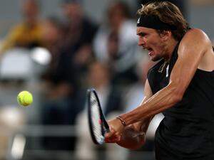 Germany's Alexander Zverev plays a backhand return to Spain's Rafael Nadal during their men's semi-final singles match on day thirteen of the Roland-Garros Open tennis tournament at the Court Philippe-Chatrier in Paris on June 3, 2022. (Photo by Thomas SAMSON / AFP)