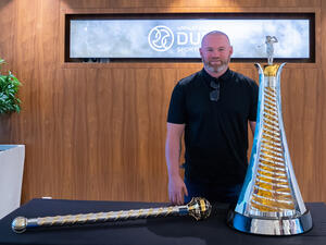 Wayne Rooney poses with the Harry Vardon Trophy and the DP World Tour Championship trophy at the Dubai Sports Council offices (Image credit: Supplied)