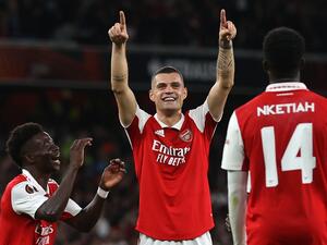 Arsenal's Swiss midfielder Granit Xhaka (C) celebrates with teammates after scoring the opening goal of the UEFA Europa League Group A football match between Arsenal and PSV Eindhoven at The Arsenal Stadium in London, on October 20, 2022. (Photo by ADRIAN DENNIS / AFP)