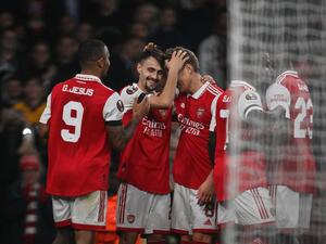 Arsenal's Portuguese midfielder Fabio Vieira (2nd L) celebrates with teammates after scoring his team third goal during the UEFA Europa League Group A football match between Arsenal and Bodoe/Glimt at The Arsenal Stadium in London, on October 6, 2022. (Photo by Daniel LEAL / AFP)