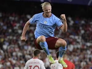 Manchester City's Norwegian striker Erling Haaland celebrates after scoring his team's third goal during the UEFA Champions League Group G first-leg football match between Sevilla FC and Manchester City, at the Ramon Sanchez Pizjuan stadium in Seville on September 6, 2022. (Photo by CRISTINA QUICLER / AFP)