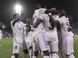 Real Madrid players celebrate their opening goal scored by Real Madrid's Brazilian defender Eder Militao during the Spanish League football match between Getafe CF and Real Madrid CF at the Coliseo Alfonso Perez stadium in Getafe on October 8, 2022. (Photo by OSCAR DEL POZO CANAS / AFP)