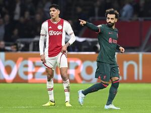 Liverpool's Egyptian striker Mohamed Salah (R) celebrates scoring his team's first goal as Ajax's Mexican defender Edson Alvarez (L) looks on during the UEFA Champions League group A football match between Ajax Amsterdam and Liverpool at the Johan Cruijff ArenA in Amsterdam, on October 26, 2022. (Photo by JOHN THYS / AFP)