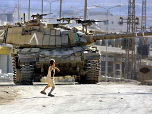 A Palestinian child faces an Israeli tank 