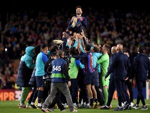 Barcelona's players lift up Spanish defender Gerard Pique at the end of the Spanish league football match between FC Barcelona and UD Almeria at the Camp Nou stadium in Barcelona on November 5, 2022. Barcelona's Pique played his last match as he announced his retirement after stellar career. (Photo by Josep LAGO / AFP)