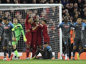 Liverpool's Egyptian striker Mohamed Salah celebrates scoring his team's first goal with teammates during the UEFA Champions League group A football match between Liverpool and Napoli in Liverpool, north west England on November 1, 2022. (Photo by Oli SCARFF / AFP)